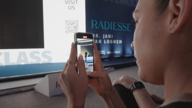 Guest filming a talk on her phone at a masterclass in Belgrade