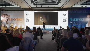 Speaker on stage at a congress, view from the audience